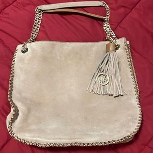 Suede MK tote purse with gold chain, fringe, and leather accents